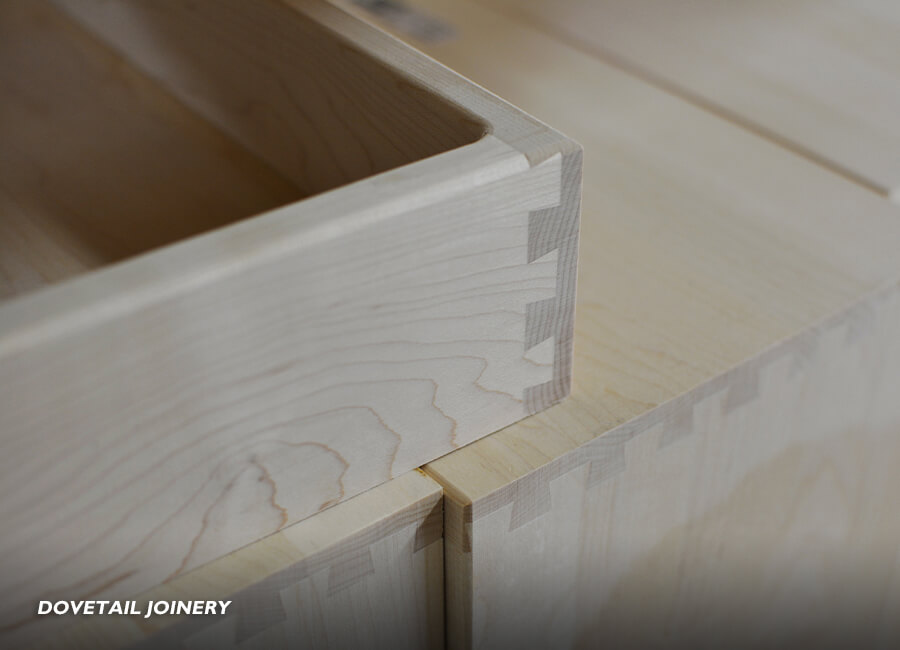 Kitchen cabinet joinery and construction methods. Here is a close up of dovetail joinery on several cabinet drawer boxes at the Dura Supreme Cabinetry factory. Dovetail joints are considered one of the strongest joints in the industry and are a fine solution for cabinetry drawer boxes.
