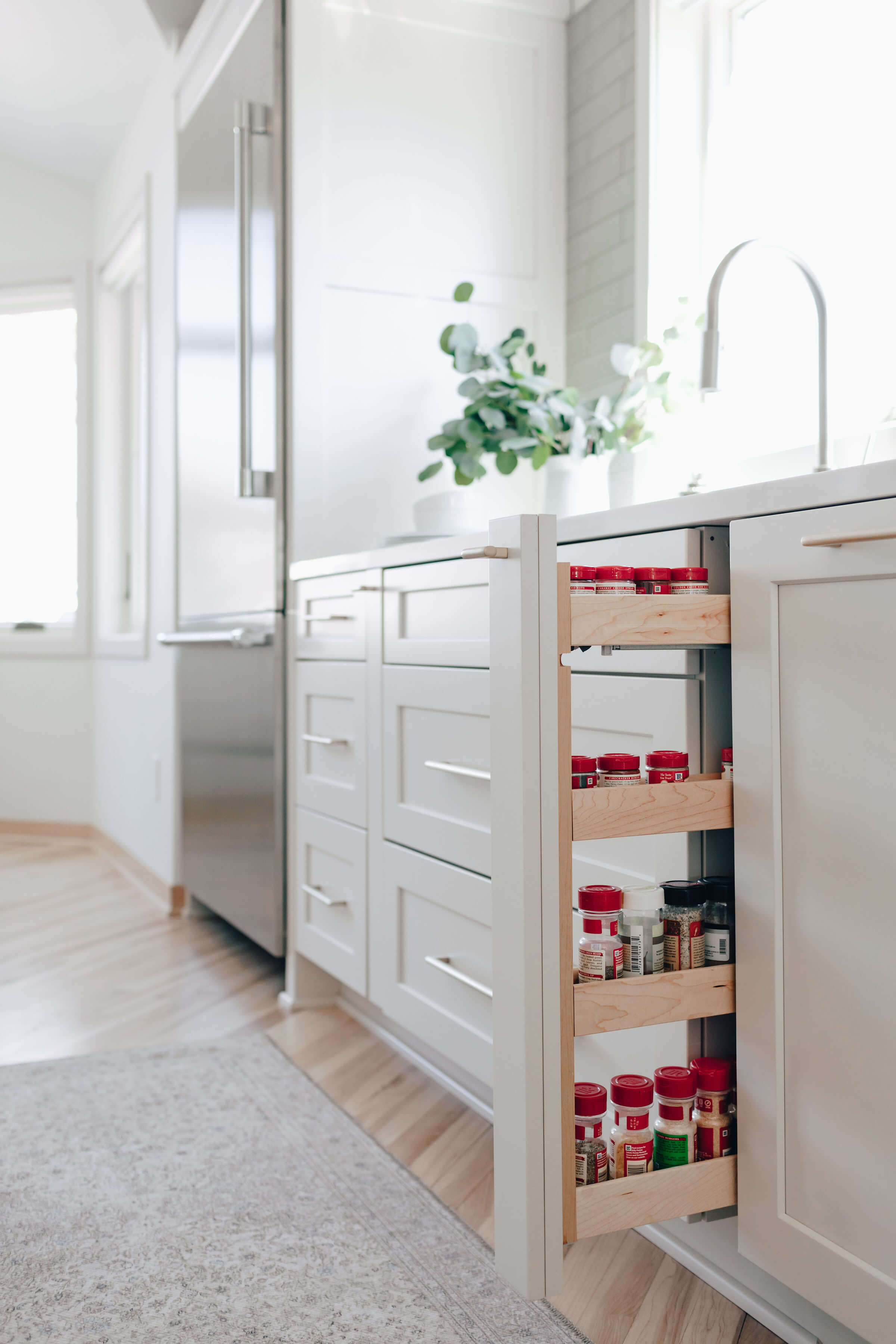 Dura Supreme's Pull-Out Spice Rack. Design by Danielle Lardani of Studio M Kitchen & Bath, Twin Cities, MN. Photo by Chelsie Lopez Production & Marketing.