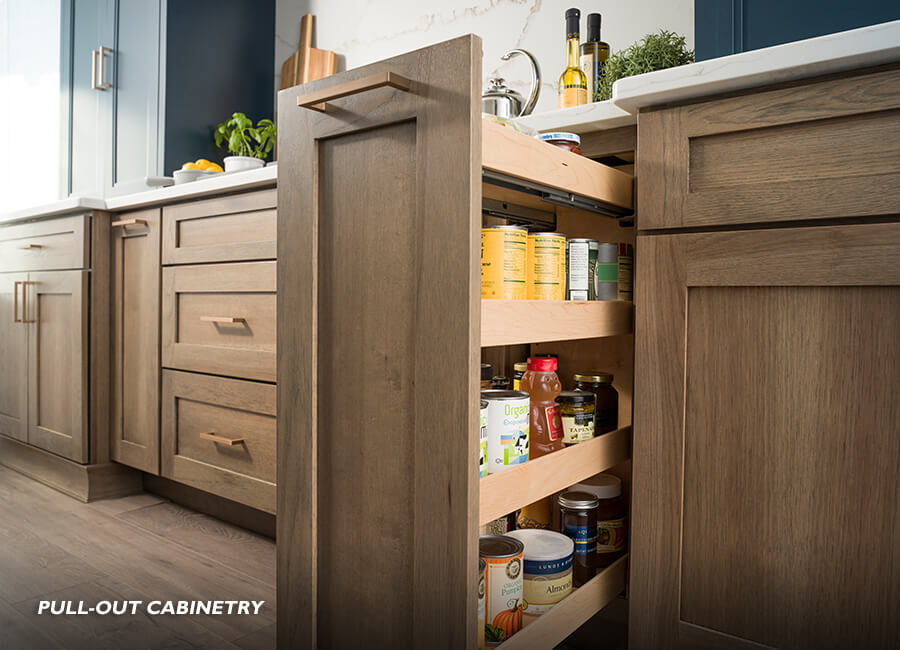 What is Pull-out kitchen cabinet storage? A cabinet storage accessory that can be opened with one motion. This is where opening the cabinet door or drawer also “pulls out” the storage accessory at the same time. This pull-out cabinet is designed for pantry storage in a base kitchen cabinet.