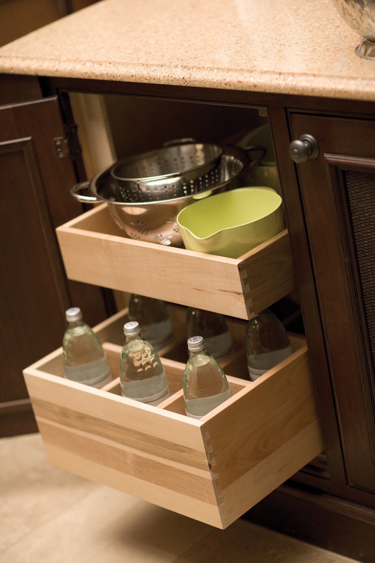 Roll-Out Bottle Rack by Dura Supreme Cabinetry with a Roll-out shelf above.