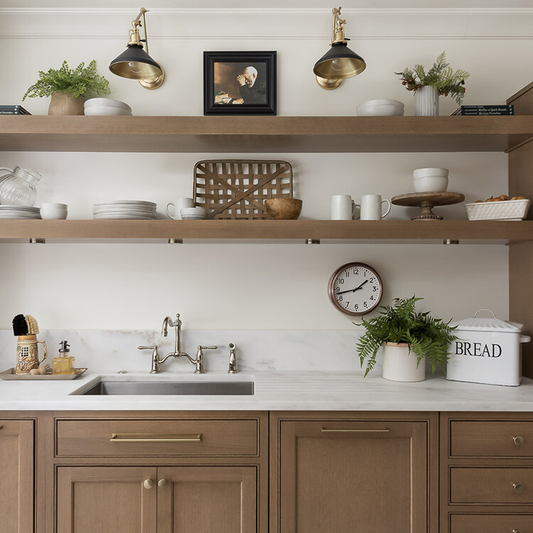 A beautiful mix of traditional inset doors with modern floating shelves. Stained white oak cabinets with a light stain in a simple scandi style kitchen design.