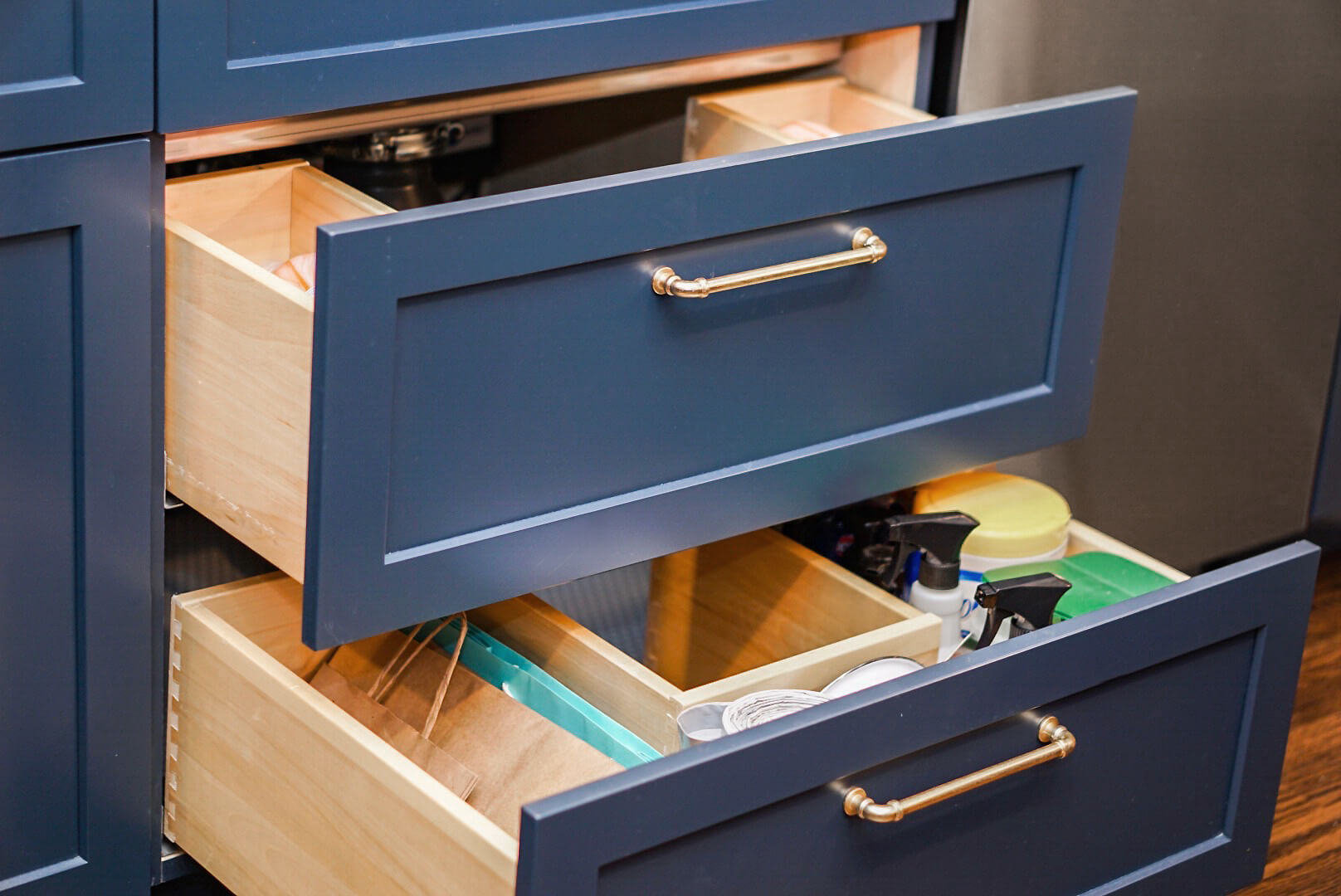 The custom sized plumbing drawers to fit around the garbage disposal and plumbing fixtures.