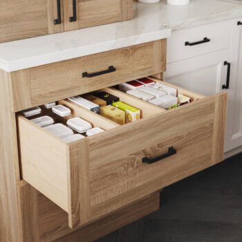 Creative kitchen cabinet storage idea. This deep drawer has stationary partitions that customize the storage for your pantry goods, bakeware, etc.