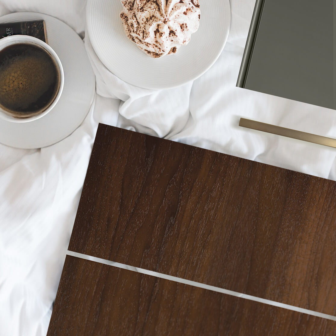 A warm stained walnut on a sleek, modern slab door style from Dura Supreme Cabinetry paired with a dark green paint sample.