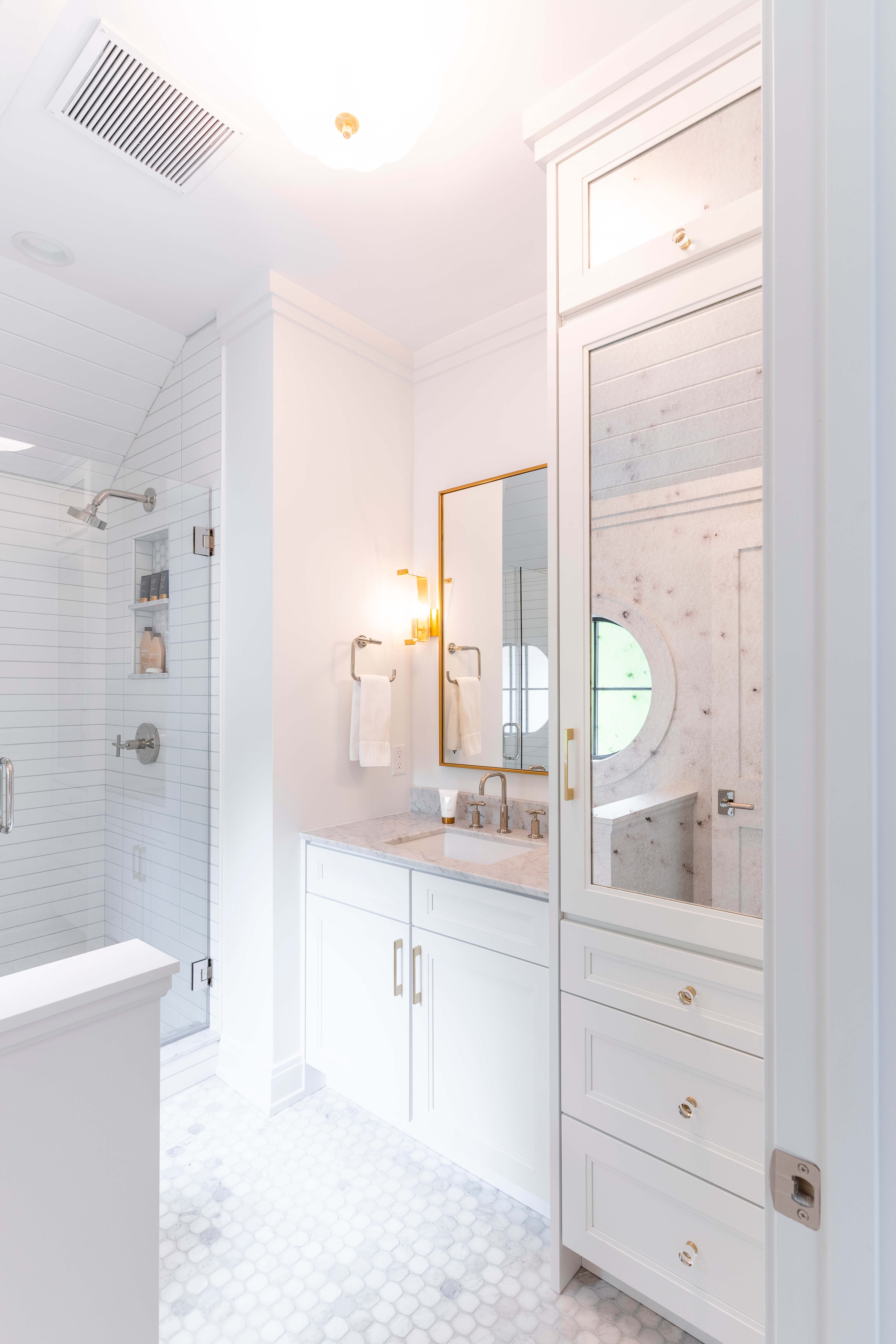 A bright all white bathroom design with white painted cabinets from Dura Supreme.