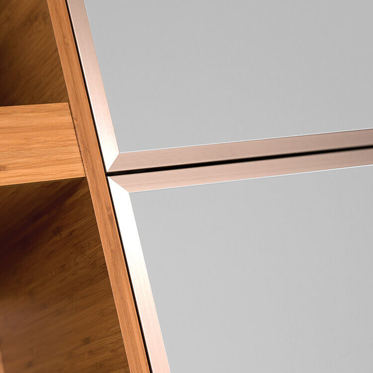 A close-up of frameless bamboo cabinets with modern aluminum framed metal accent doors.
