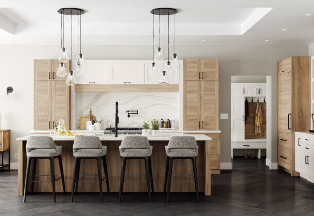 This kitchen has an American take on Scandinavian interior design style. The design features the slab Dash cabinet door style with wood plank-like details in a rustic oak texture mixed with a shaker door style in white paint. This kitchen island offers seating for four plus a kitchen sink across from the cooktop.