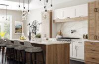 A Scandinavian styled kitchen with American-made kitchen cabinets with a lofted oak plank doors with white painted shaker doors.