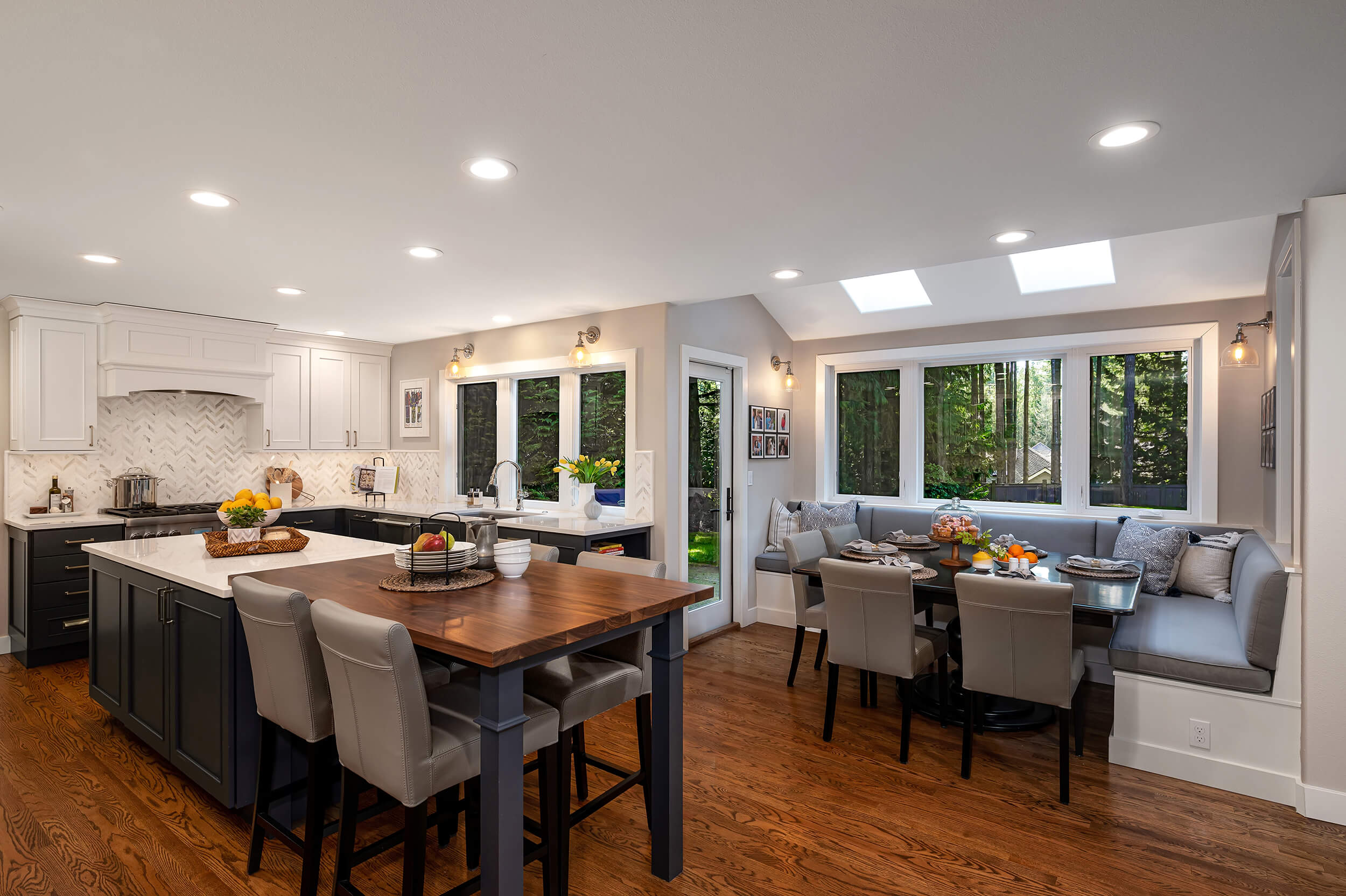 A kitchen and dining room design with a built-in breakfast nook.