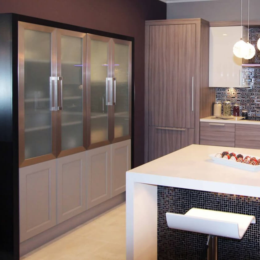 A contemporary kitchen design with multiple cabinet colors and materials.