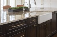 Dark stained kitchen island with an apron sink and a traditional style.