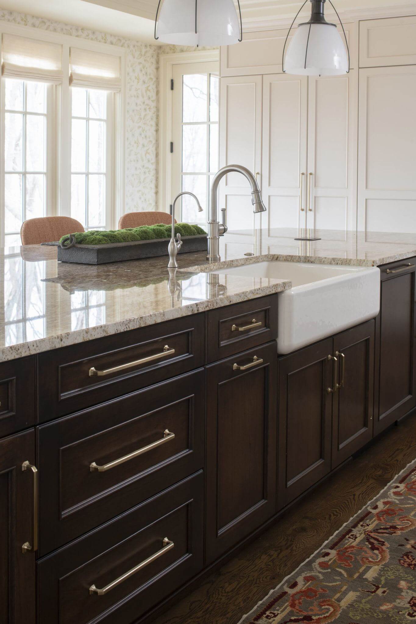 Dark stained kitchen island with an apron sink and a traditional style.