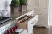 The drawer next to the stove and cooktop has a large spice rack for sorting and displaying a full spice collection.