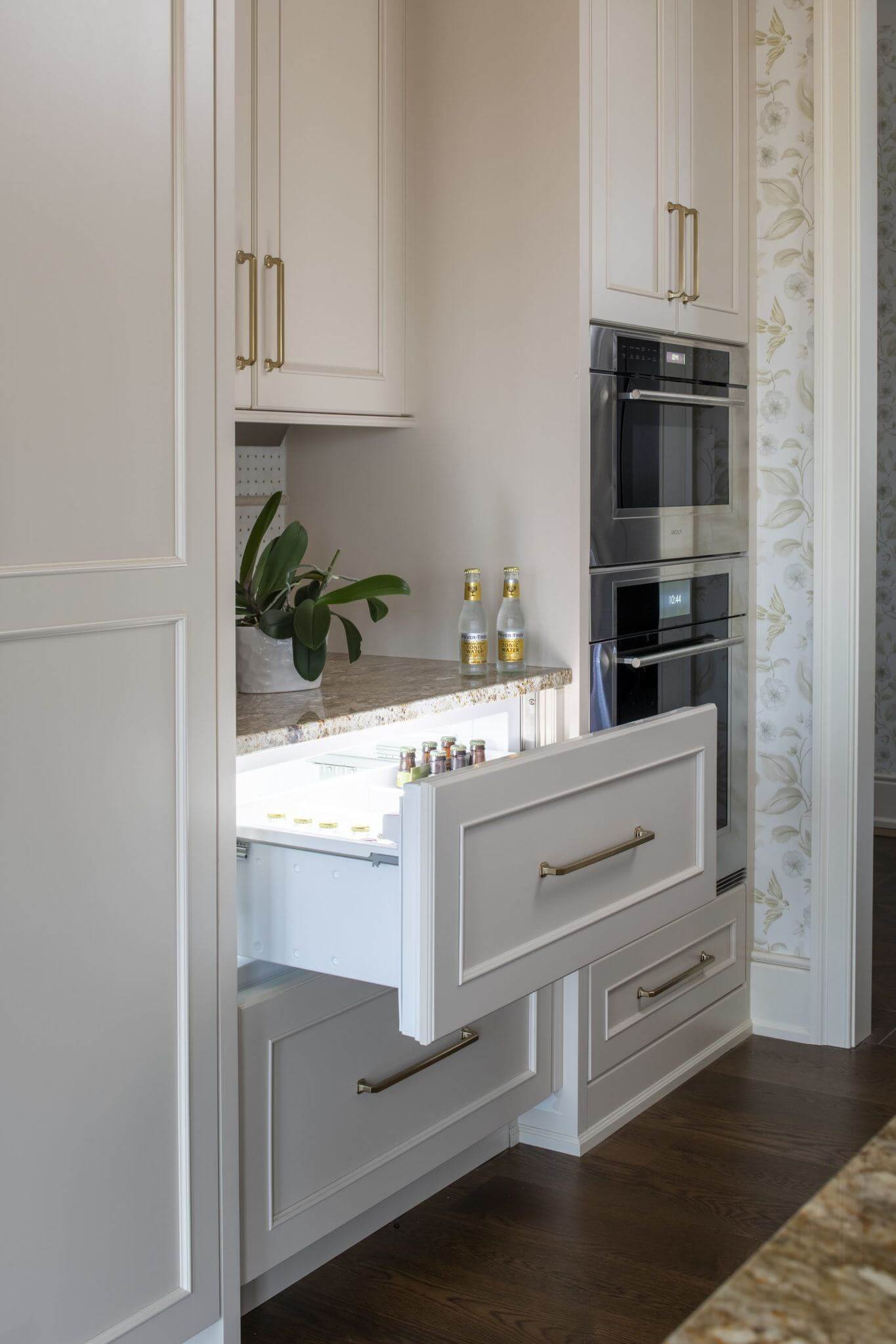 White painted cabinets with an appliance paneled beverage drawer.