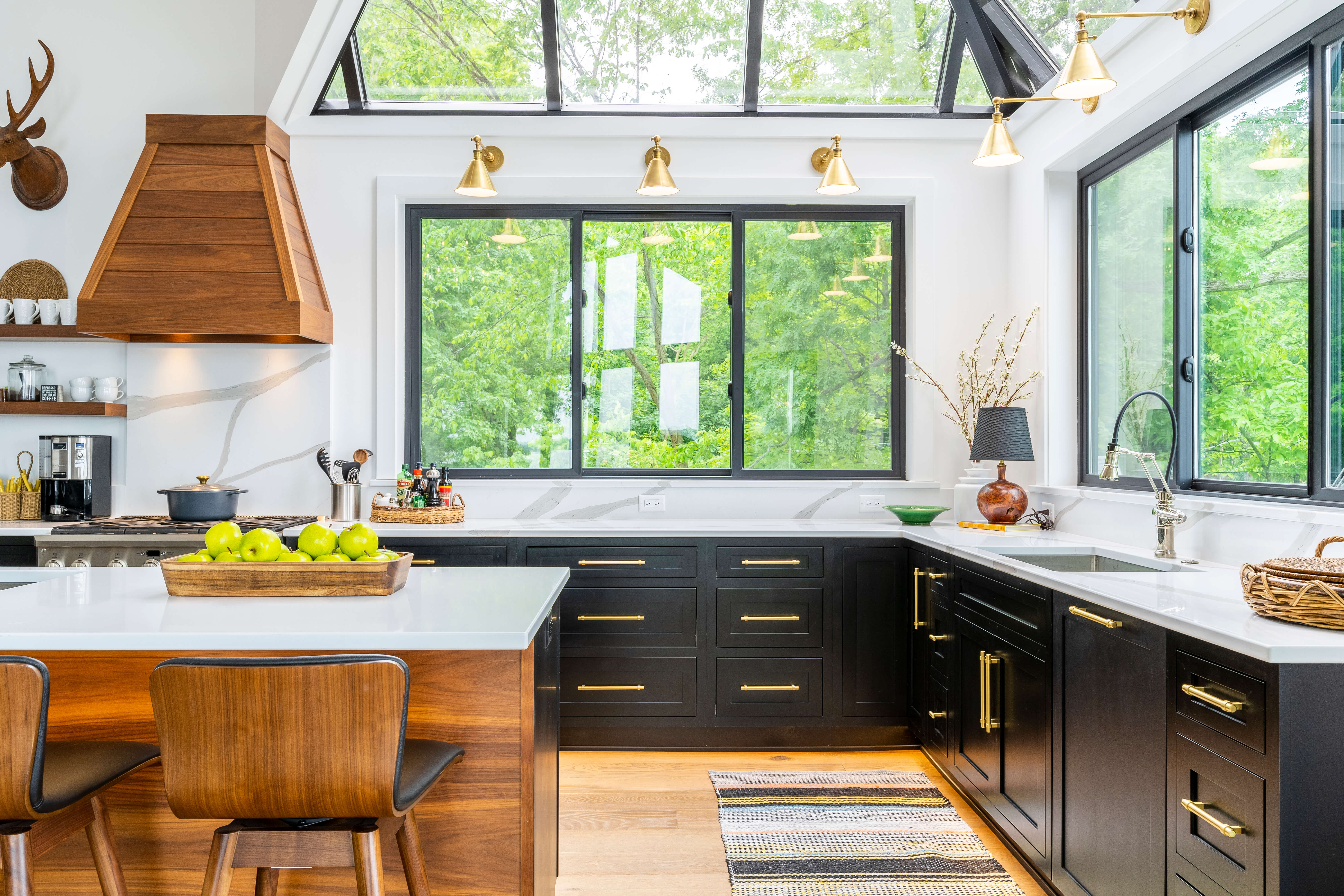 A black kitchen with bright white walls and lots of natural light.