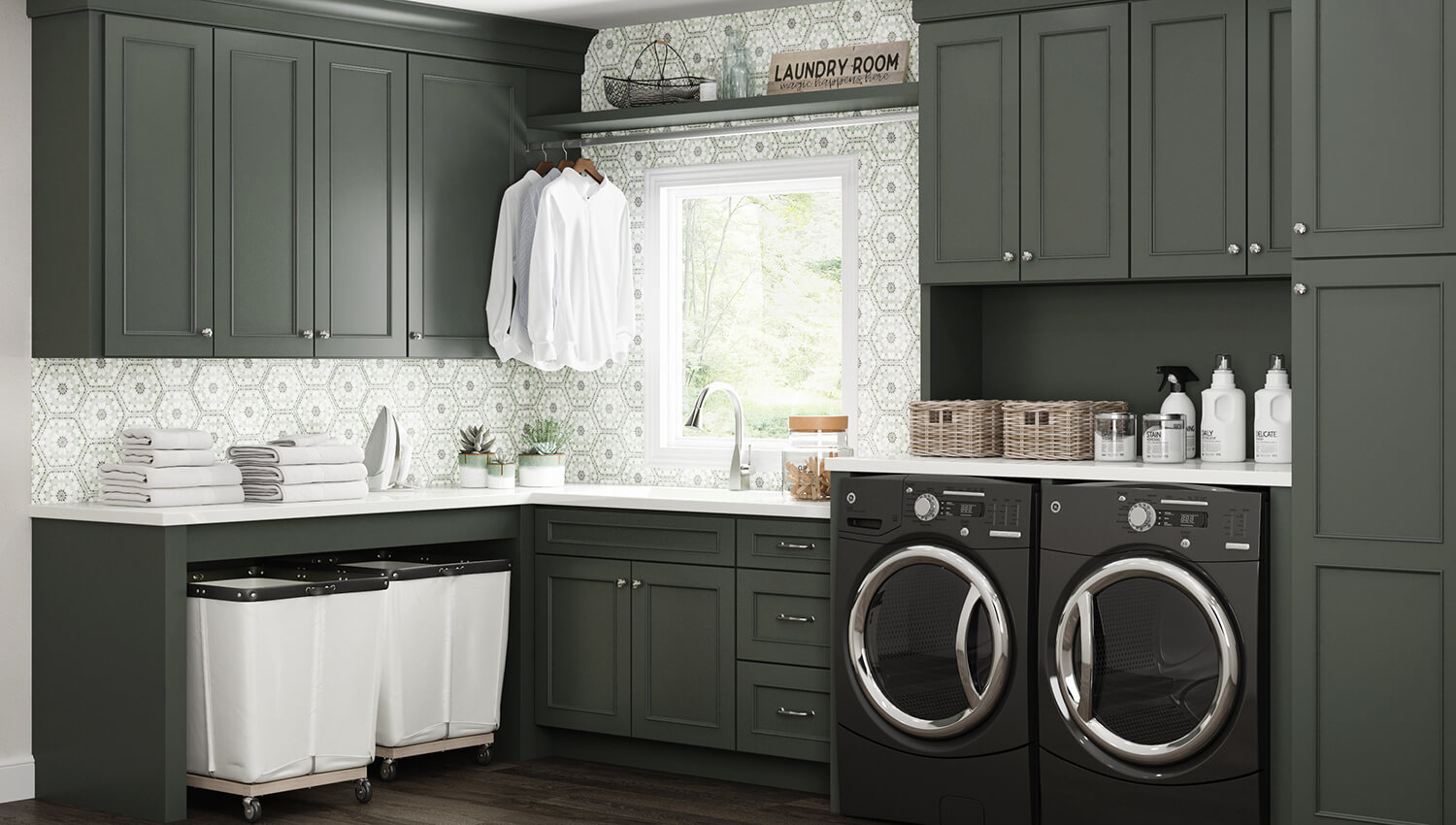 Dark olive green painted cabinets with a custom paint match finish using Dura Supreme's Personal Paint Match program to perfectly match the finish to Sherwin-Williams Rock Bottom paint color. A detailed hand-painted backsplash tile complements the color of the cabinetry throughout the room.