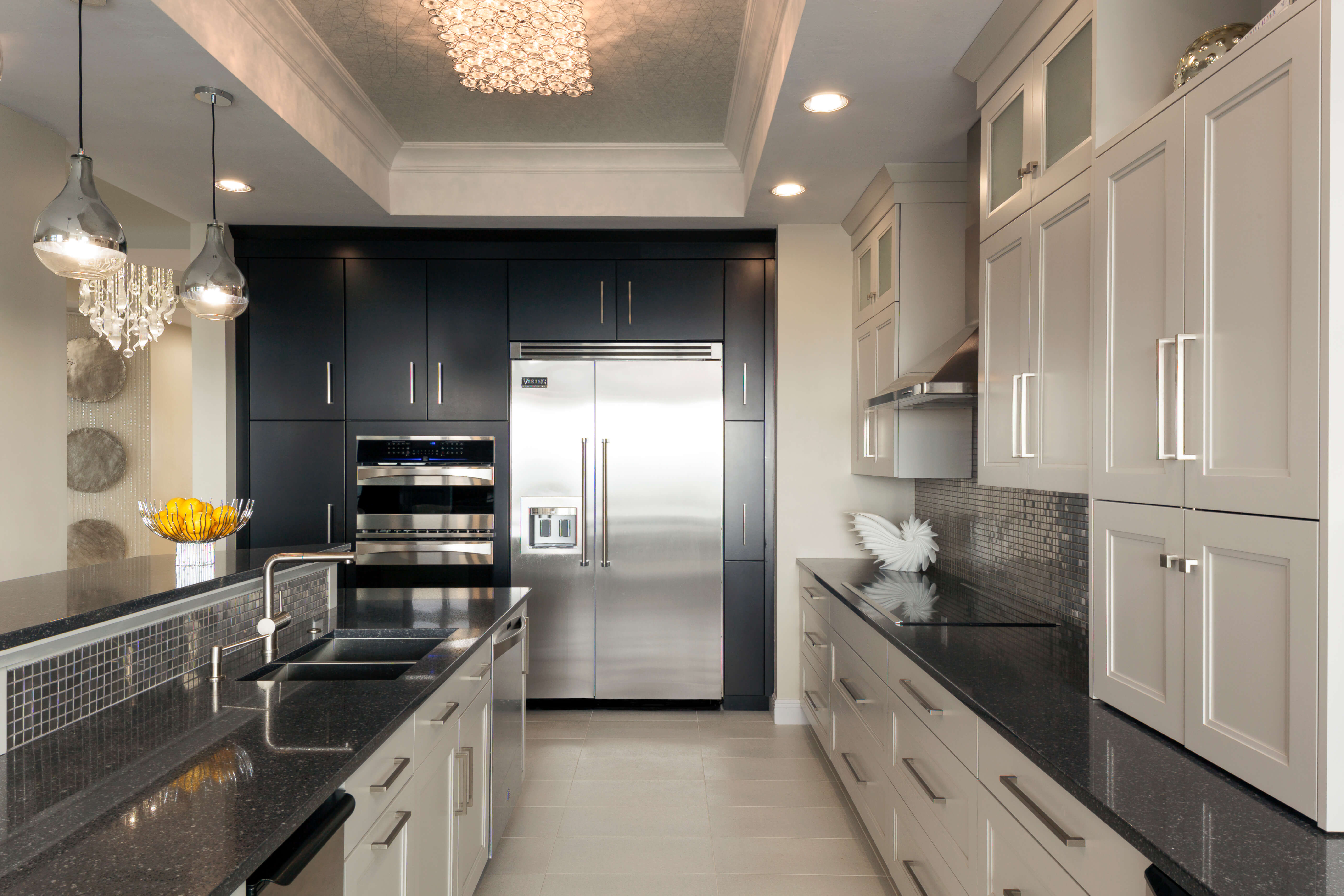 A black and white kitchen with a sleek transitional style.