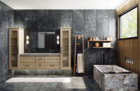 This monastic and intimate bathroom unites cool and warm natural tones with a shallow shaker cabinet door style in a light stained White Oak. Dark floor-to-ceiling tiles create a moody look.