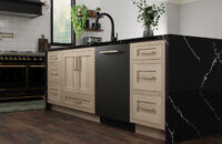 A white oak and white painted kitchen with black accents including a black kitchen appliances, faucets, and countertops.