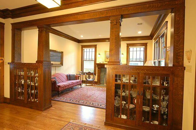 A craftsman styled home with a built-in cabinet space that highlights the door way into the adjacent room.