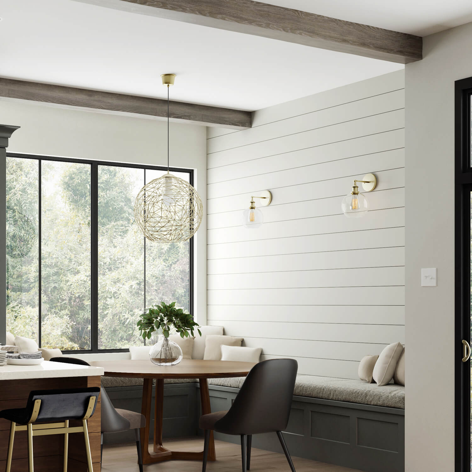 Dark gray-green and rich stained wood kitchen with a breakfast nook and built-in seating in a new modern farmhouse. A shiplap accent wall adds a farmhouse style to the dining area.