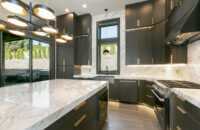 An all black kitchen with modern textured cabinets from Dura Supreme Cabinetry.