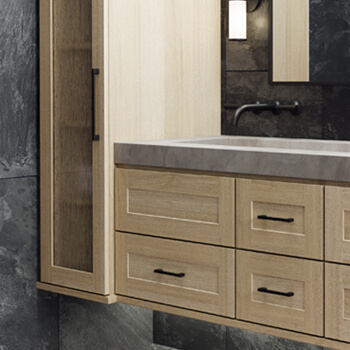A floating vanity in a contemporary bathroom with a shallow shaker door style in a light raw quarter-sawn white oak color.