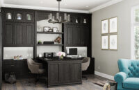 Black stained home office desk for two with a wall of storage an a peninsula desk for a double work station.