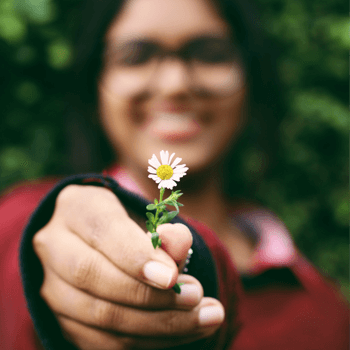 Dura Supreme has achieved ESP certification by demonstrating our commitment to sound environmental management and sustainable practices. A woman holds a flower and enjoys mother nature thanks to sustainable manufacturing.