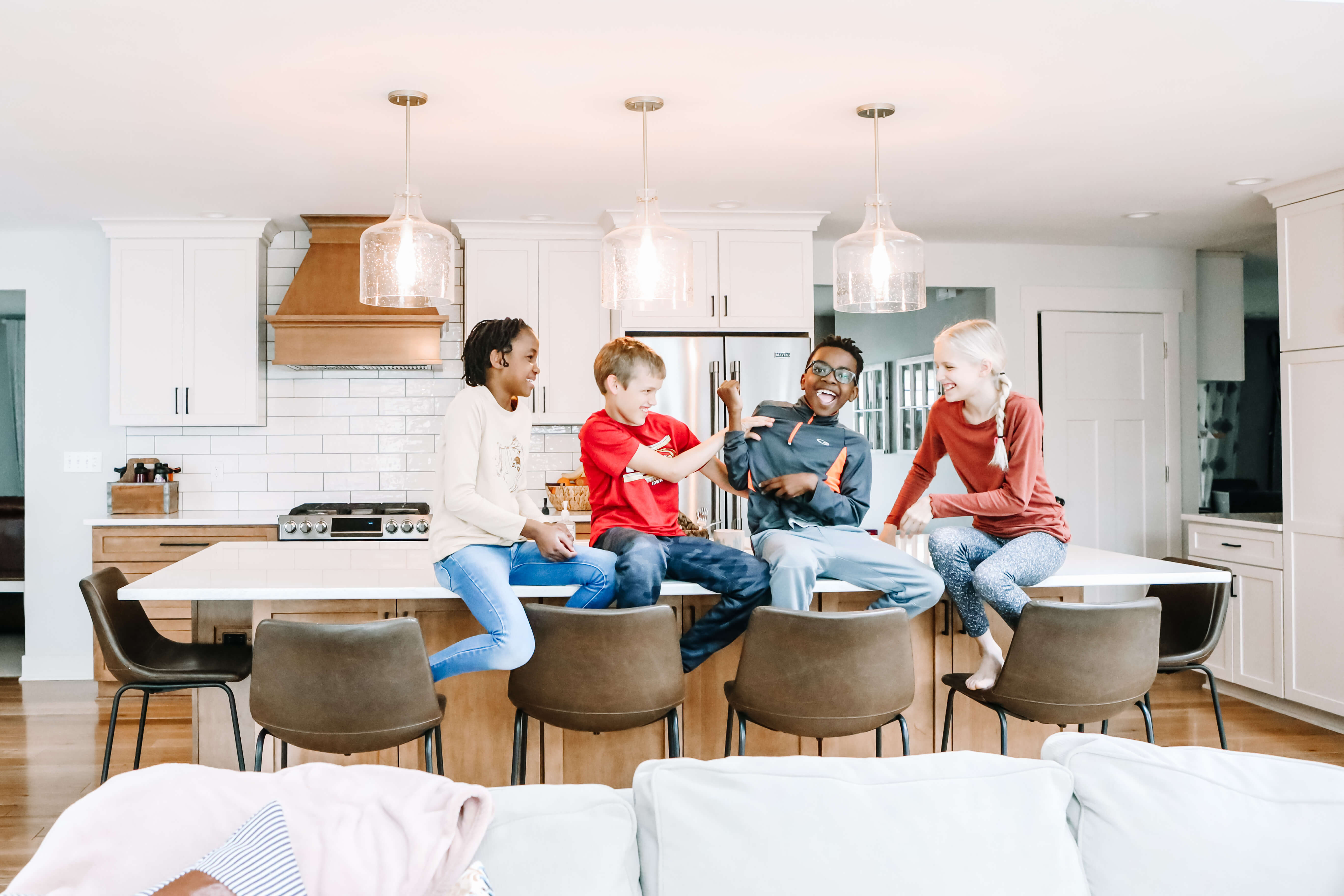 A happy family with four kids enjoys their new Dura Supreme kitchen.