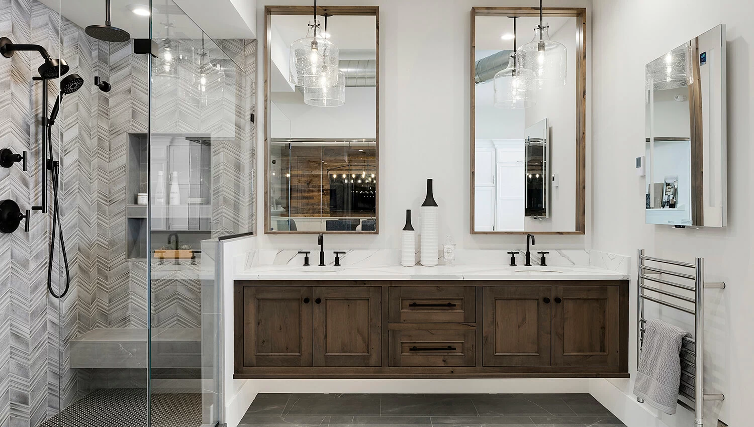 A transitional styled master bathroom with a floating vanity featuring two sinks and a dark, true-brown stain color on knotty alder cabinets.