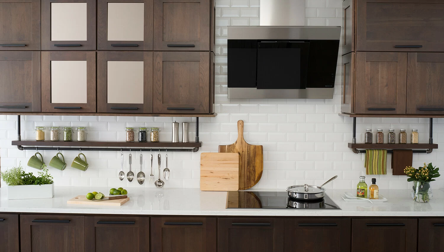This industrial styled kitchen showcases Dura Supreme’s Craftsman Panel door style in the dark, true-brown Poppy Seed stain on Cherry with accented Bronze Mirror inserts.