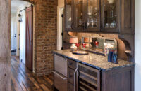 A rustic wet bar in a wide hallway.