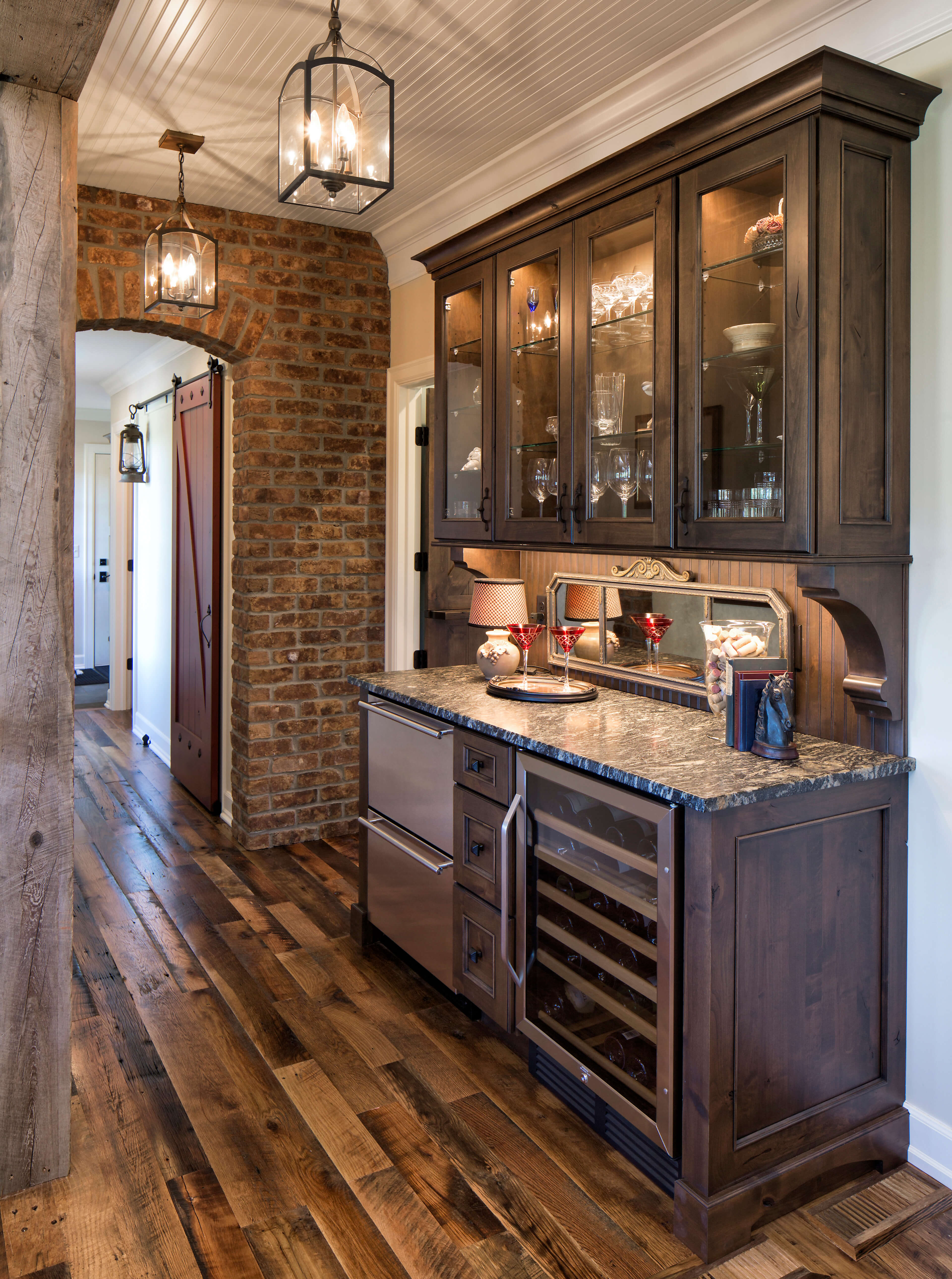 A rustic wet bar in a wide hallway.