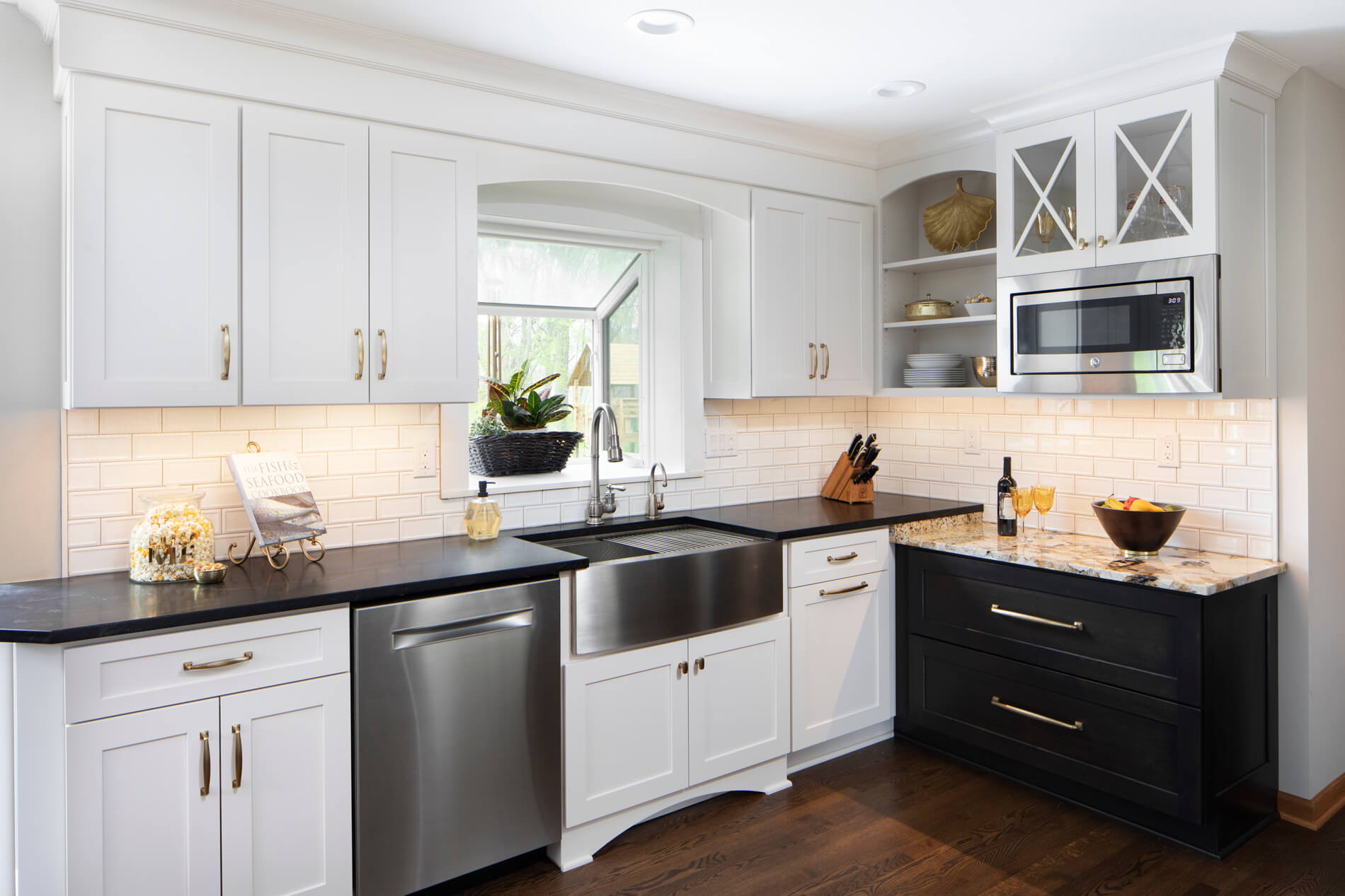 A beautiful remodeled kitchen with Dura Supreme Cabinets showing the view towards the stainless steel apron sink.