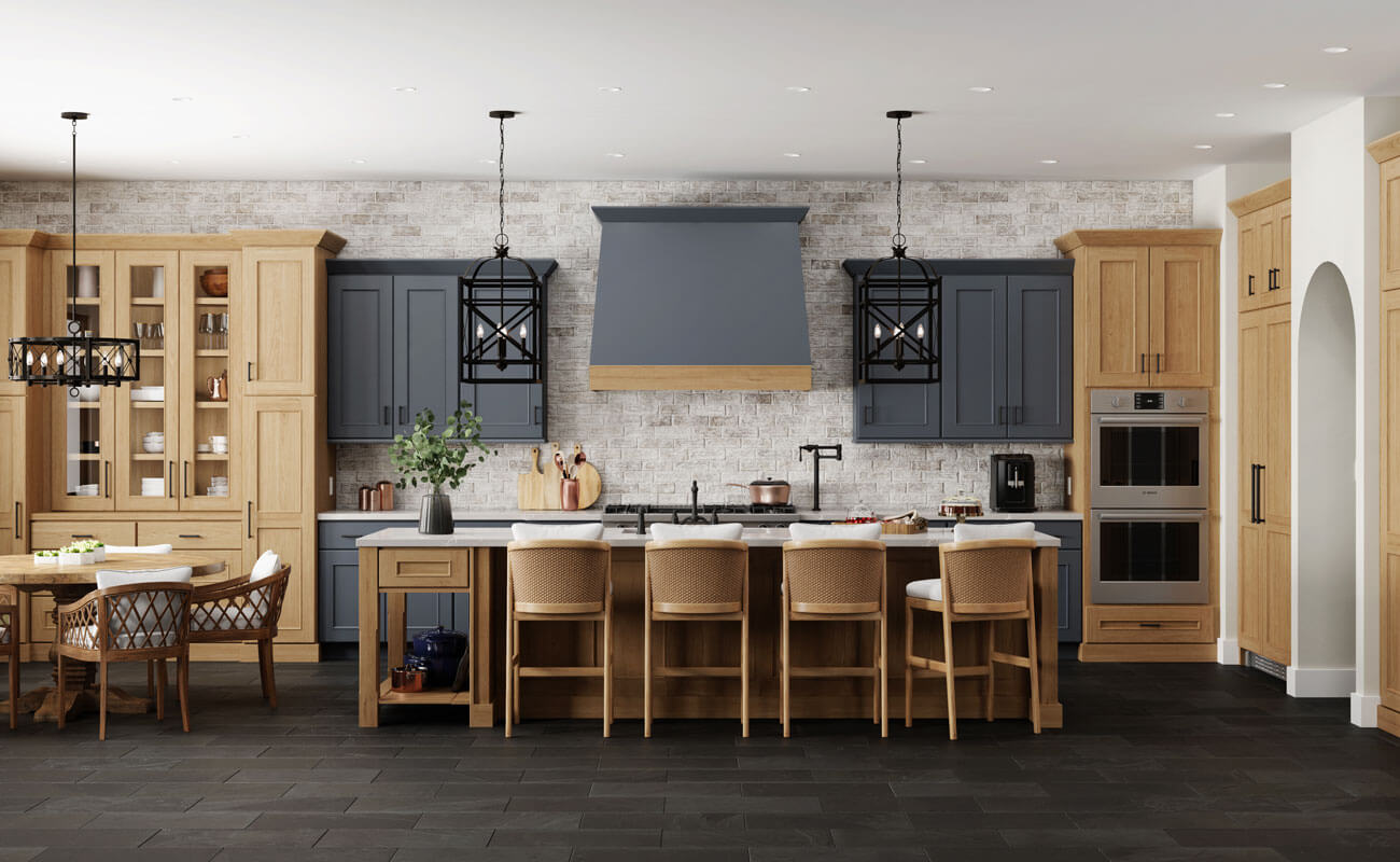 An English-style modern farmhouse with dark navy blue painted cabinets and warm light stained cabinets from Dura Supreme Cabinetry's Crestwood product line of traditionally framed construction.