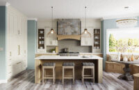 This dreamy lake house kitchen captures the home’s lake shore lifestyle with watery blue walls, shiplap ceilings, nature-inspired wood and white painted cabinetry, and natural stone accents.