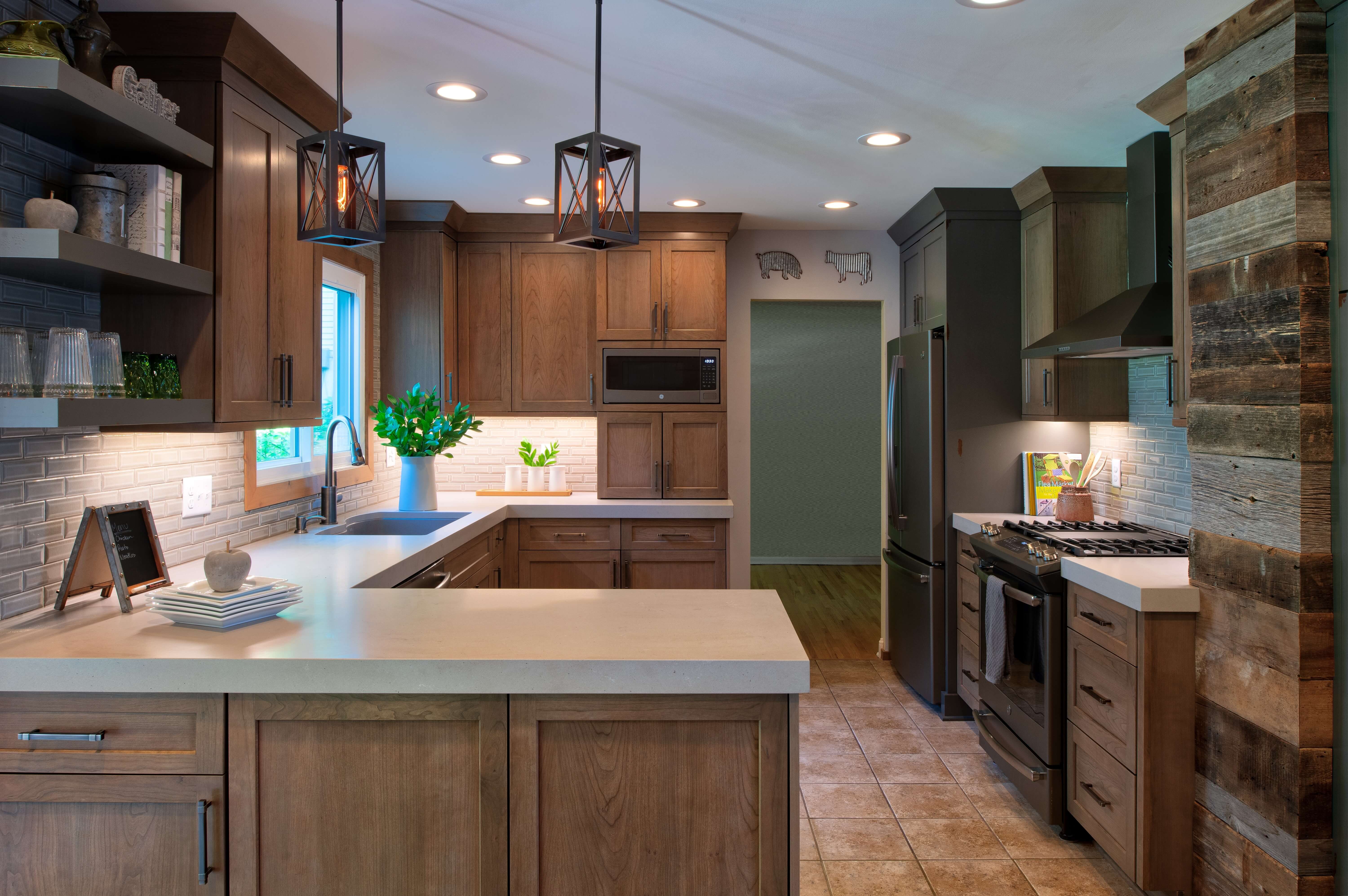A stunning industial style kitchen dseing with wood cabinets and distressed painted cabinets with a rustic look.