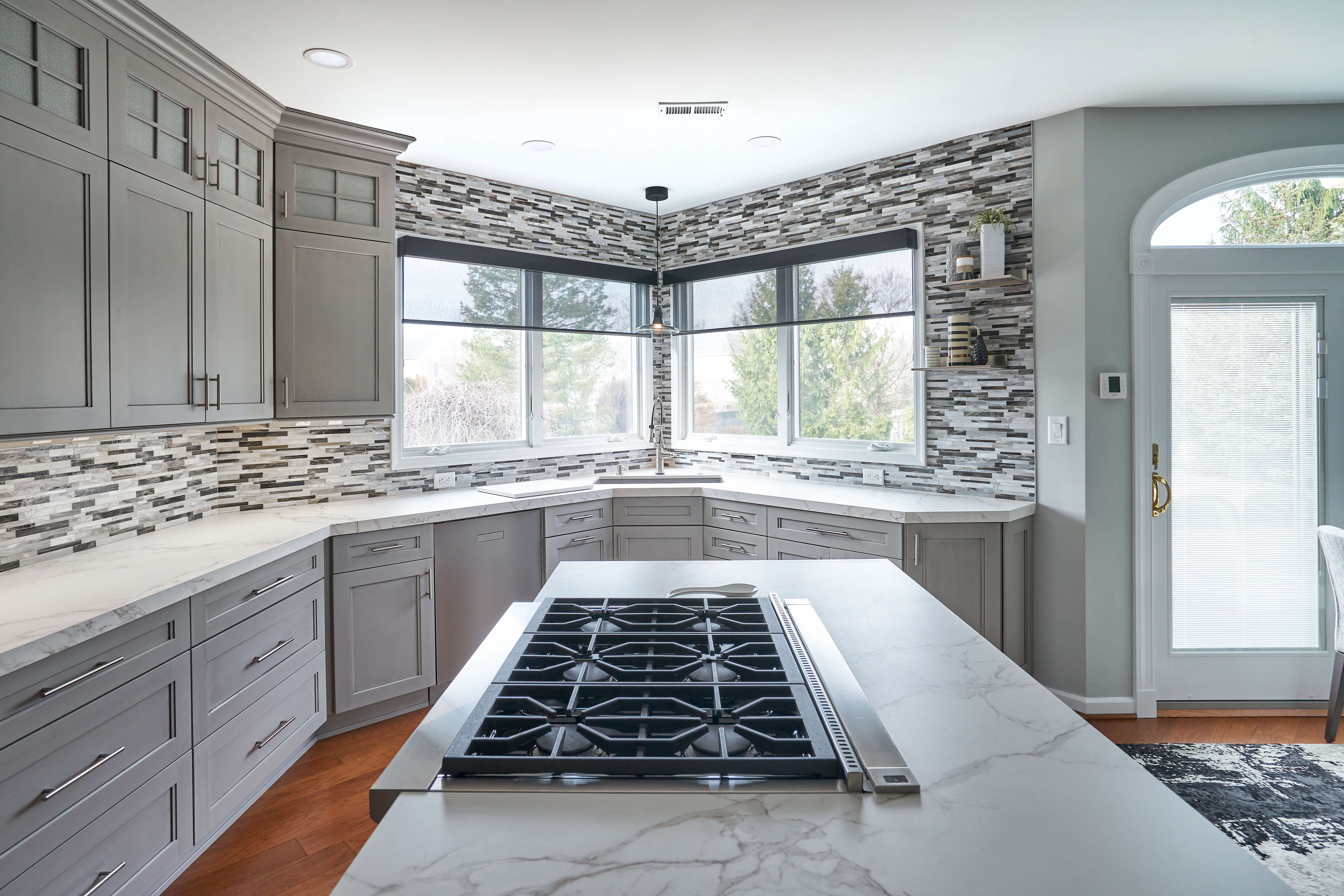 An all gray kitchen design with a black painted kitchen island.