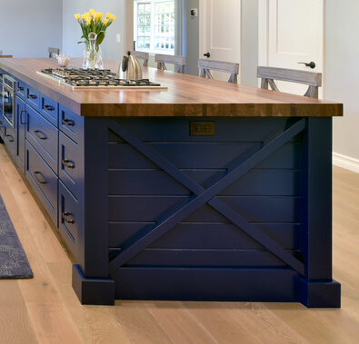 a Nautical style kitchen island with a navy blue painted finish and an X-end-cap with shiplap details.