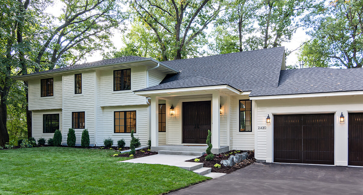 The after image of a remodeled home exterior with a new expanded addition to the house.