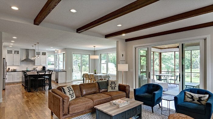 A look from the living room into the kitchen with Dura Supreme cabinets and straight laid ceiling beams.