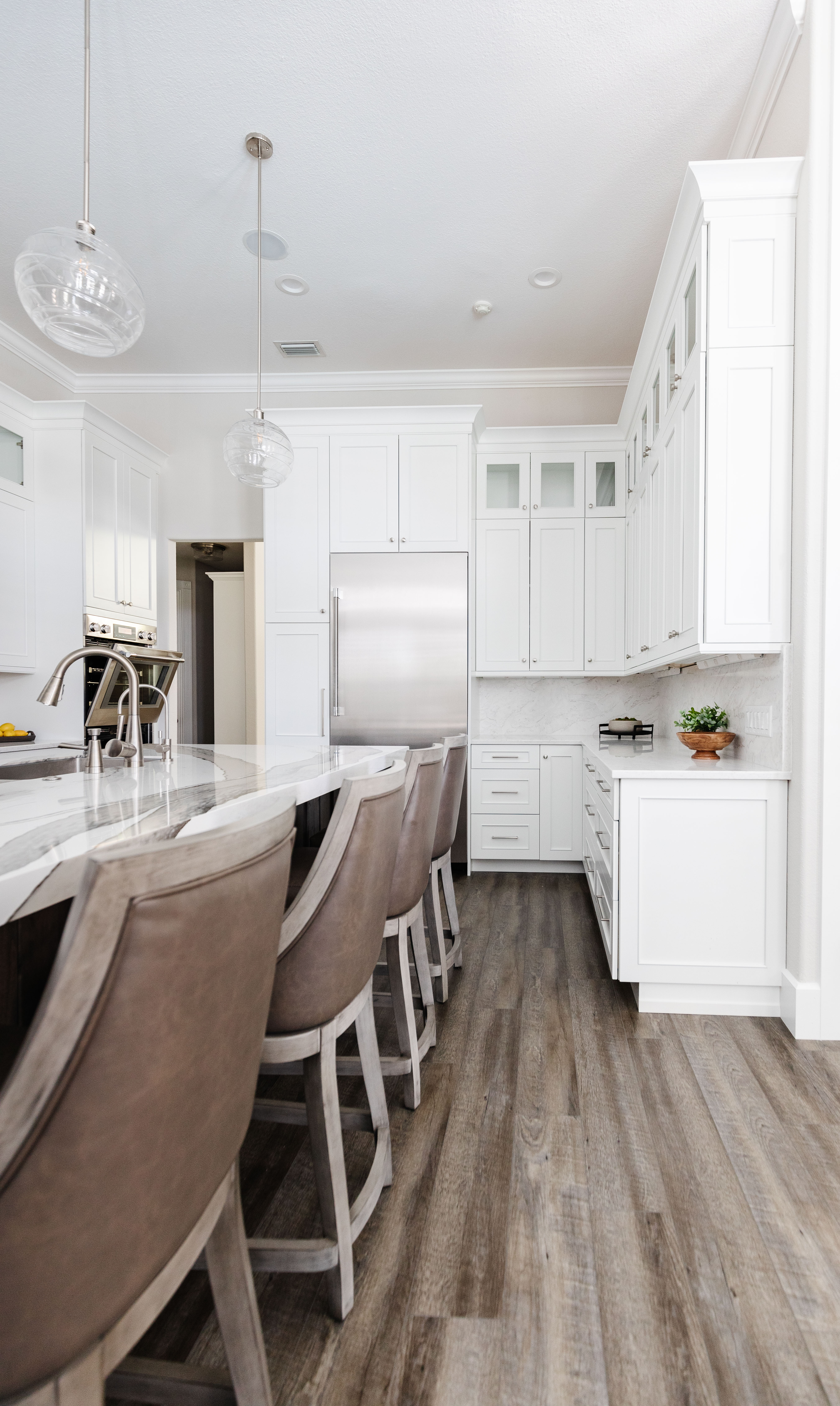 A classic kitchen design with white painted kitchen cabinetry and a large knotty alder kitchen island.