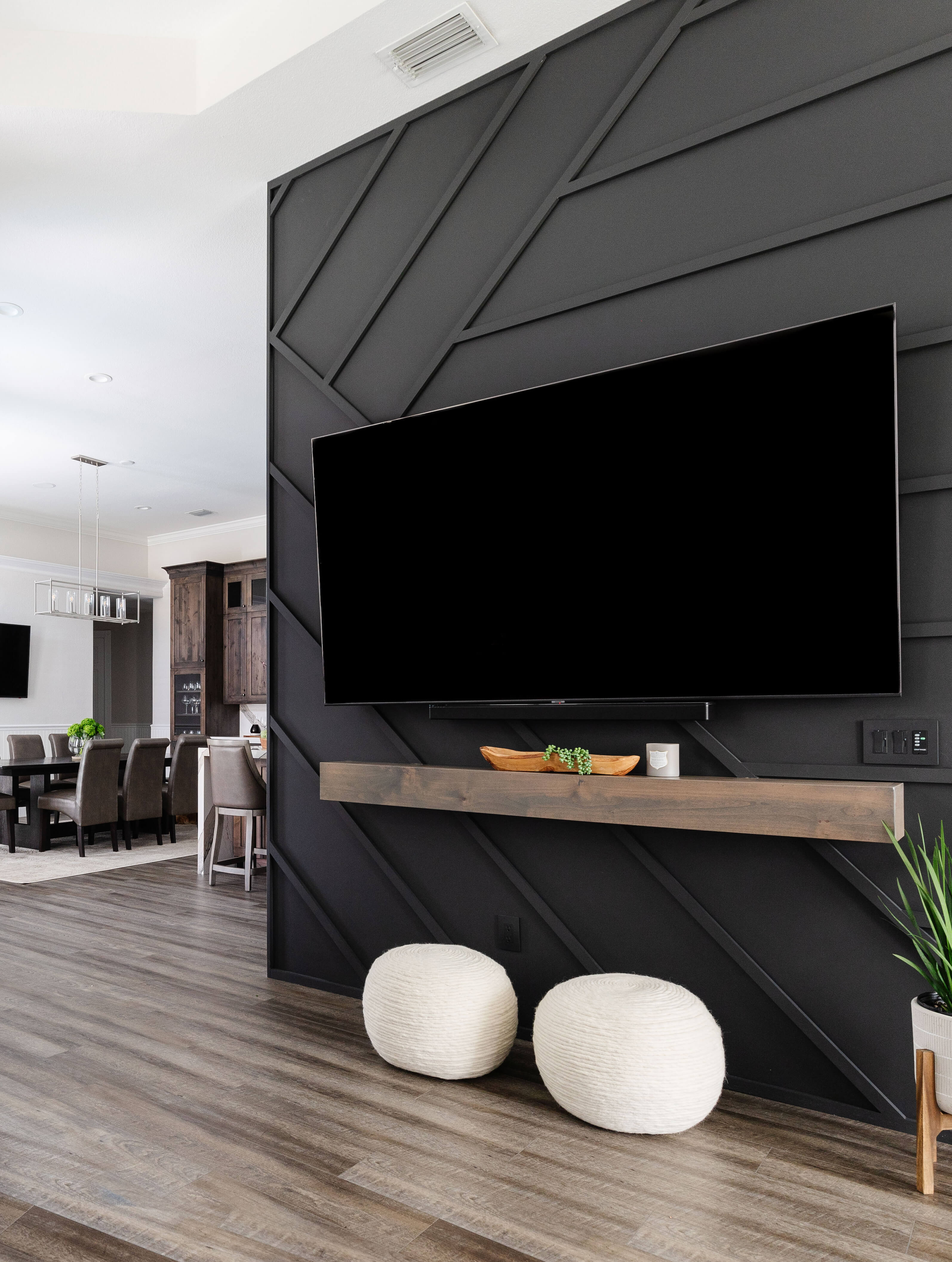 The TV wall was transformed into an accent wall with black painted boards in a fun, modern pattern.
