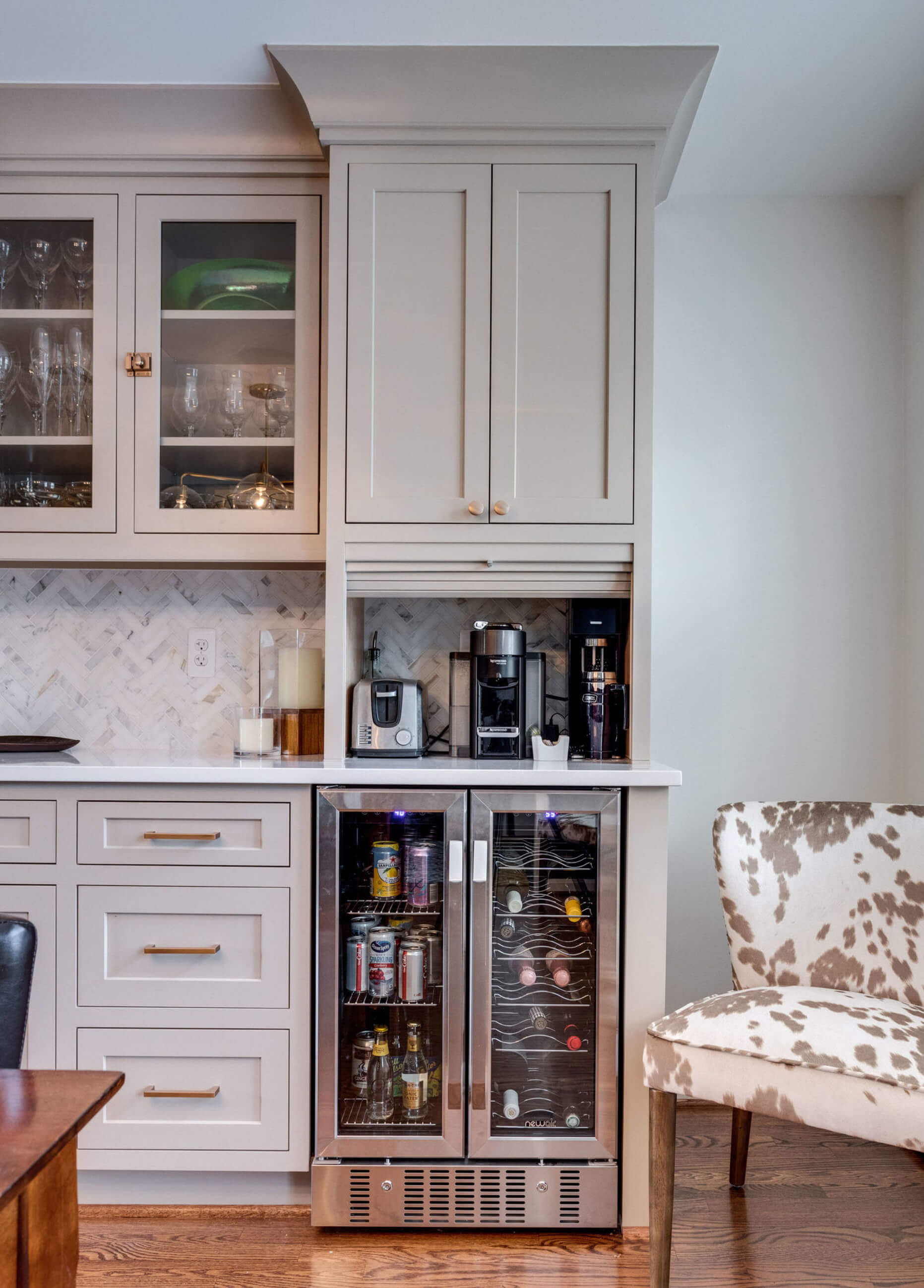 A mini-beverage center near an under-the-counter beverage fridge desgined as a hub for crafting beverages and making quick breakfast items on the go.