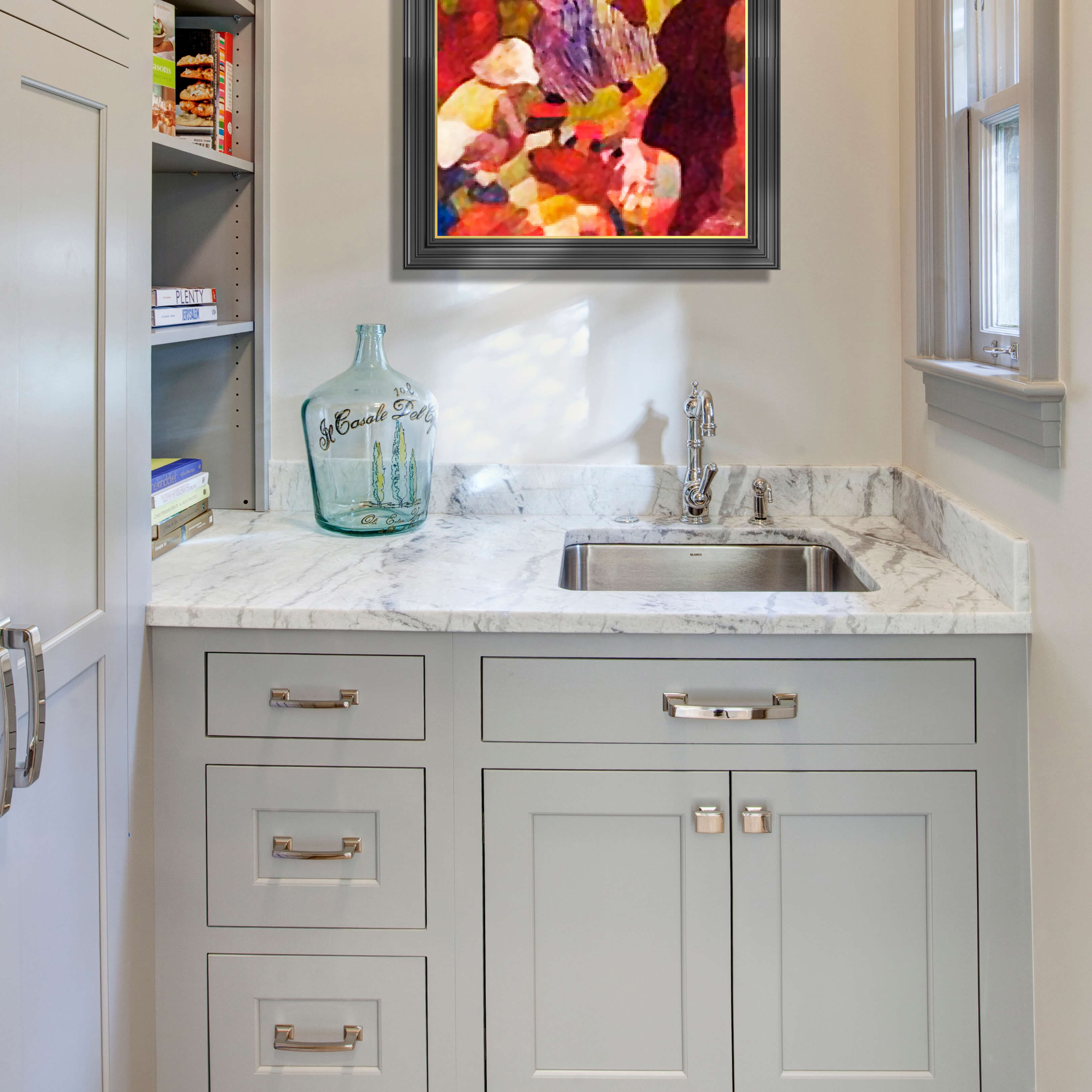 A light gray butler's pantry design with a small prep sink and open shelves tucked into the wall.