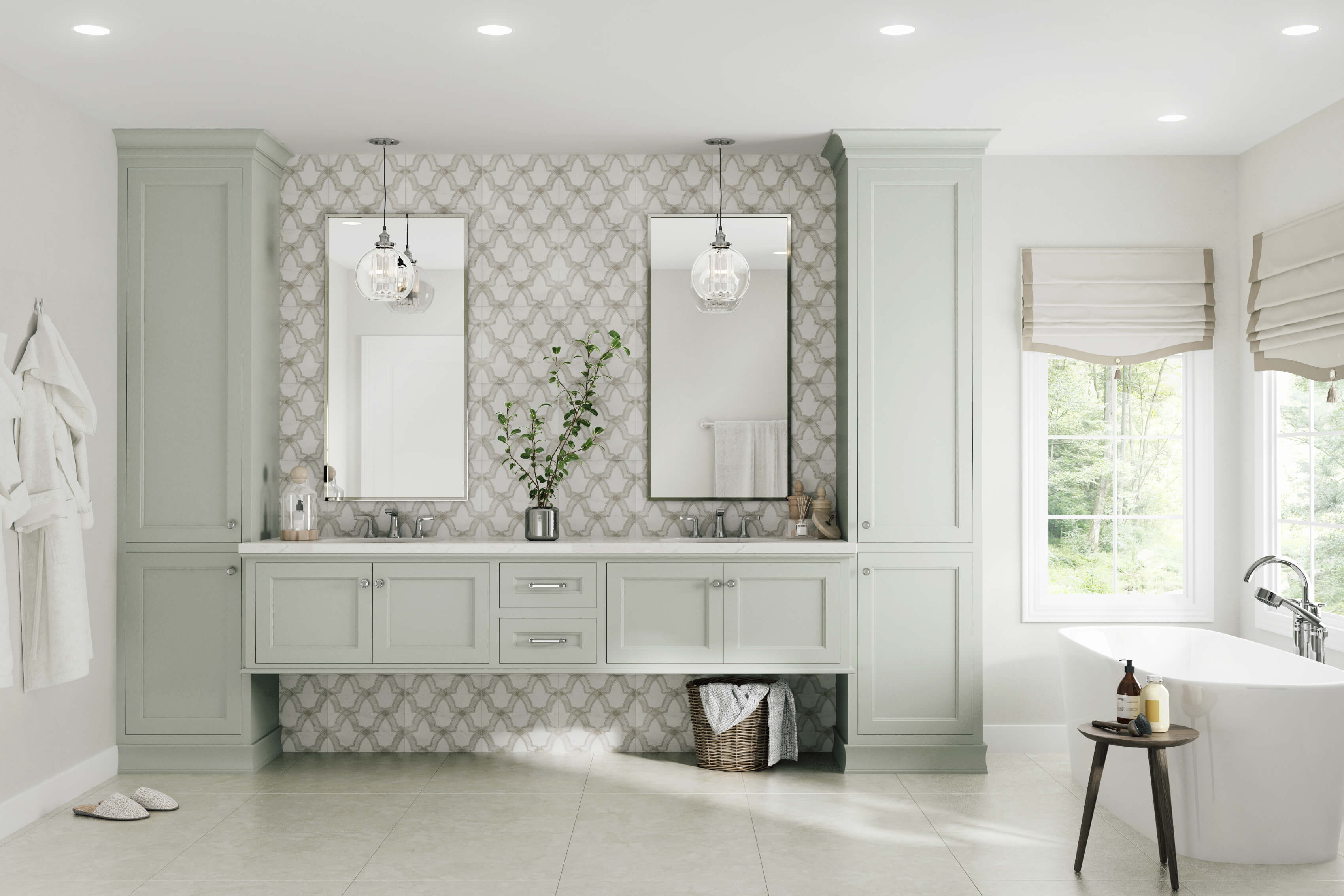 A transitional style master bathroom with a white and light gray color palette. A floating vanity in a soft gray painted finish is framed by two tall linen cabinets that stretch from the floor to the ceiling along with the floor-to-ceiling backsplash tiles. A freestanding bathtub sits near two large windows with views to the backyard.