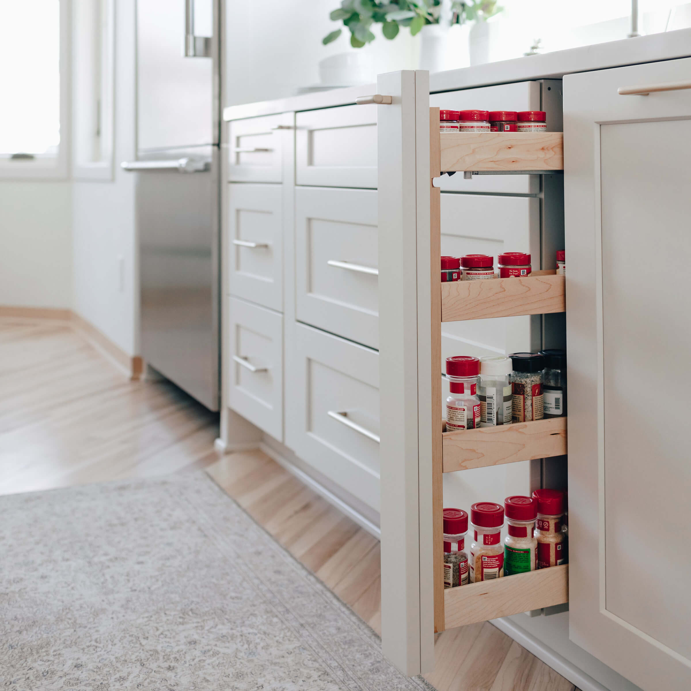 A pull-out spice rack in a thin base cabinet.