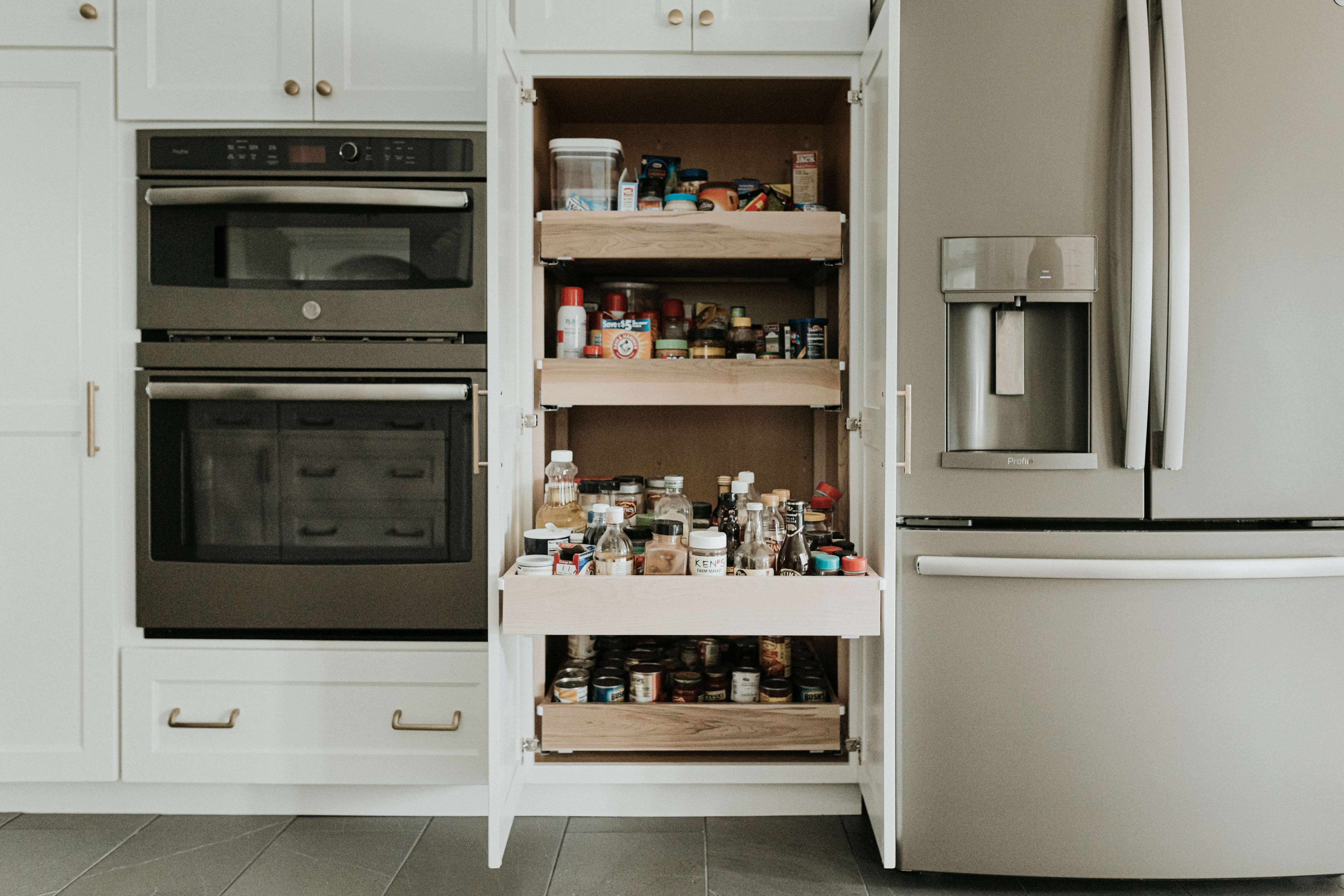A large pantry cabinet with several roll-out shelves.