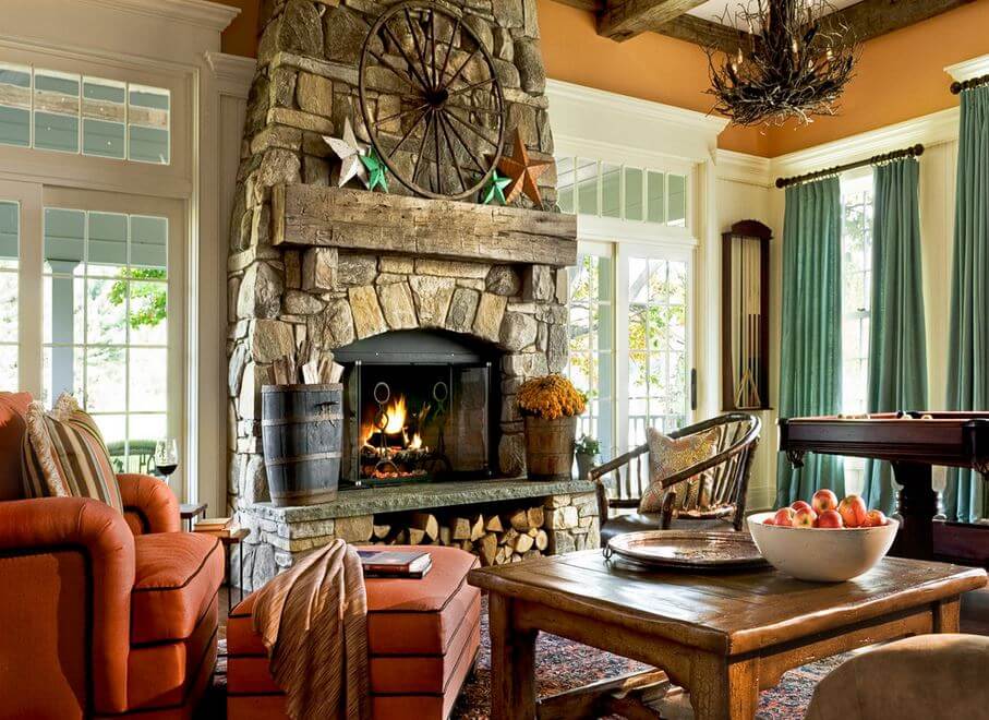 A rustic style living room with a natural stone fireplace and reclaimed mantel in a cozy farmhouse.